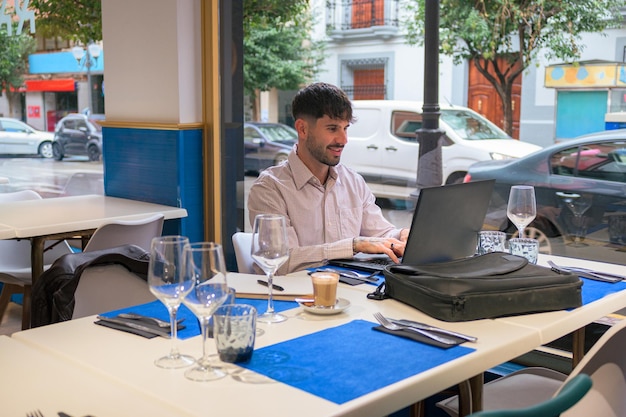 Man works remotely from a restaurant