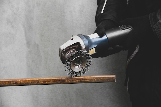 A man works with an angle grinder