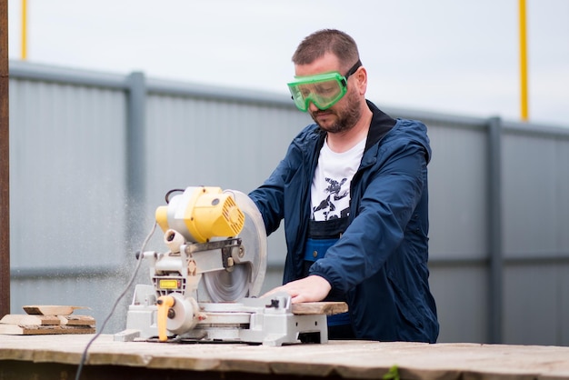 The man works with trimming saw  A rare working profession