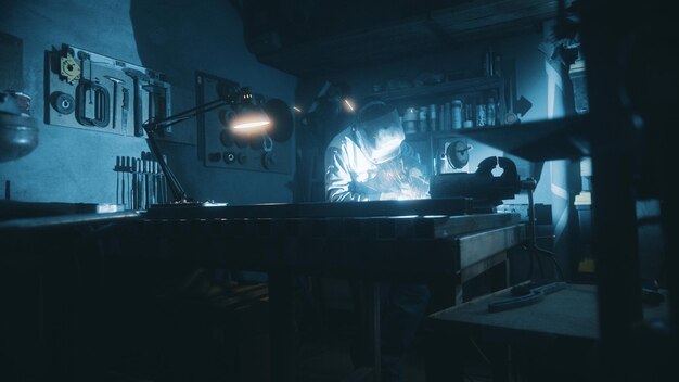 A man works with a welding machine at a factory