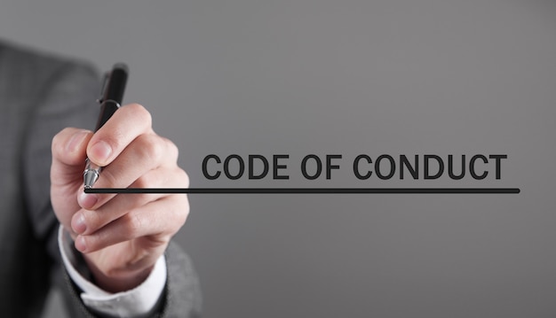 Man writes Code Of Conduct text in screen.