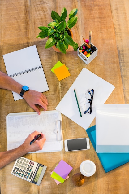 Man writing on clipboard