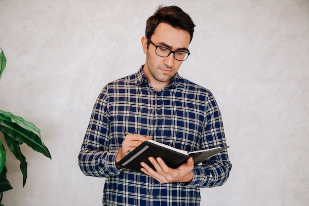 Man writing his plans into his diary. Business concept.