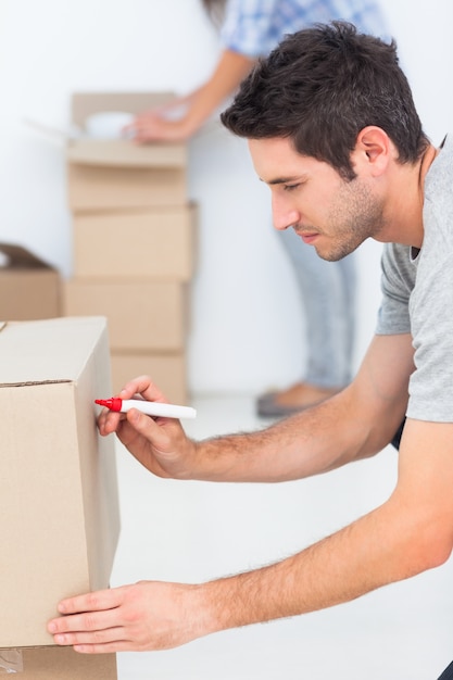 Man writing on a moving box