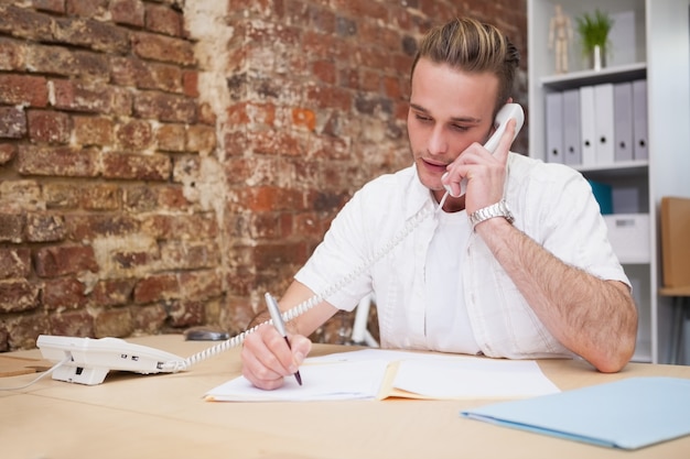 Man writing notes while on call