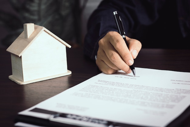 Man writing and sign on contract of house