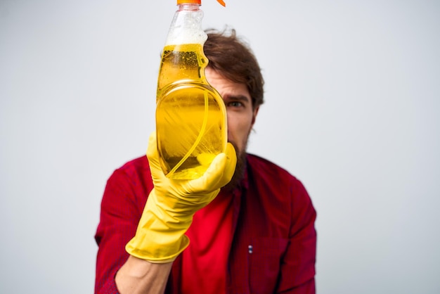 Man in yellow gloves detergent cleaning professional cropped view of housework lifestyle