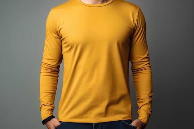 A man in a yellow shirt is posing for a picture with his hands in his pockets and his hands in his p
