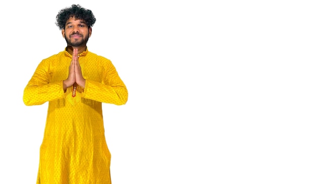 A man in a yellow shirt is standing in front of a white background.