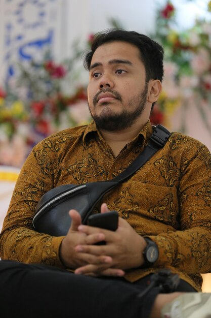 A man in a yellow shirt with a black and yellow pattern on it