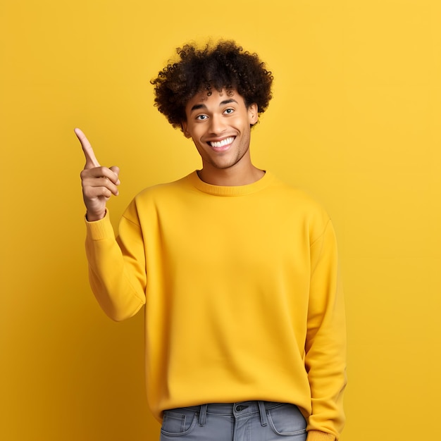 A man in a yellow sweater is pointing to the left with a yellow background