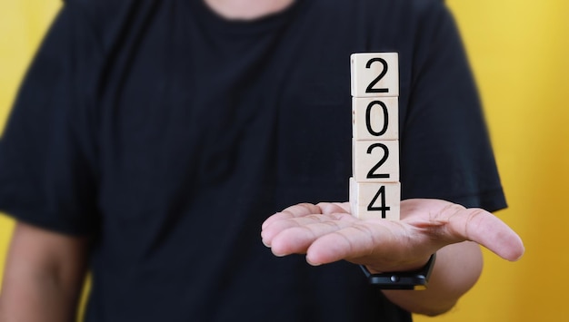 Man39s hand in casual holding 2024 blocks text new year concept