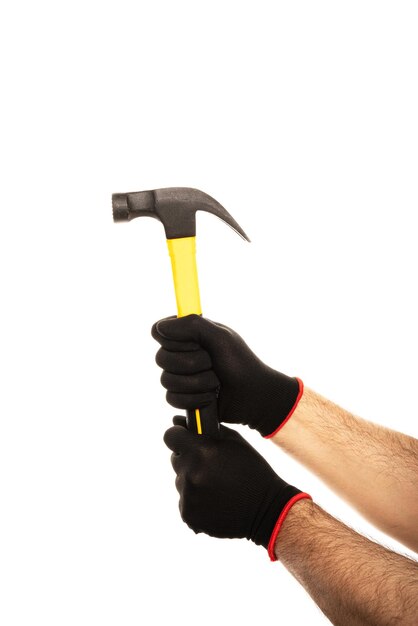 Man39s は、白い背景で隔離の黄色のハンマーを保持している建設用手袋で手します。