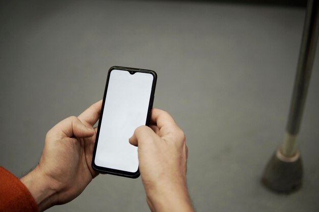 Man39s hands taking cell phone in the subway