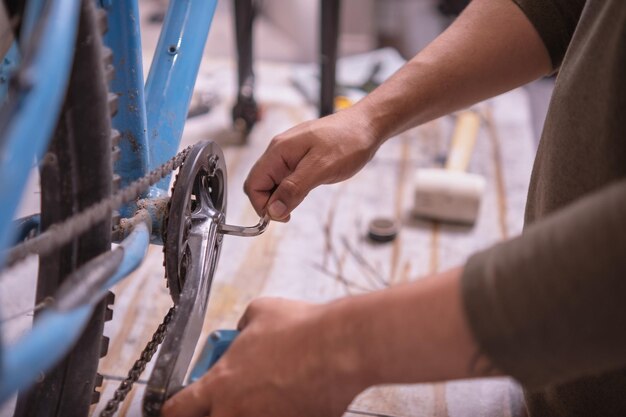 Man39s hands tightening a crank of a bicycle