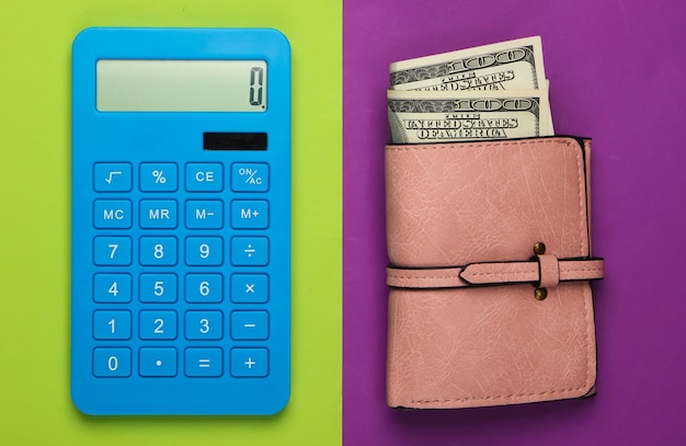 Manage family budget. Shopping costs. Blue calculator and leather wallet with dollar bills on purple green