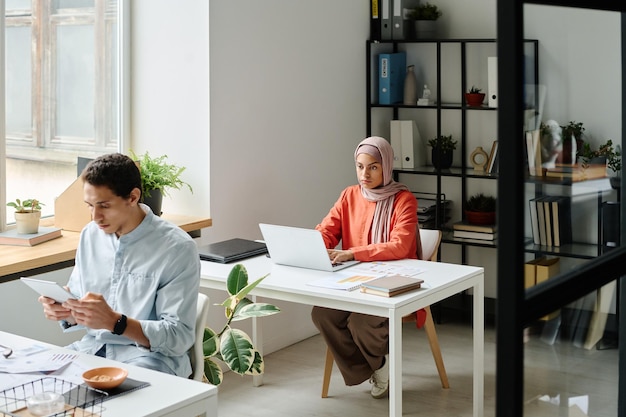 Manager analyzing data on laptop screen