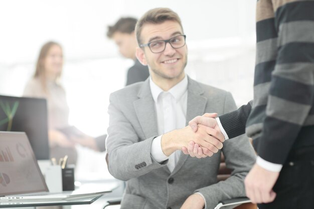 Manager and the client shake hands when meeting in the office