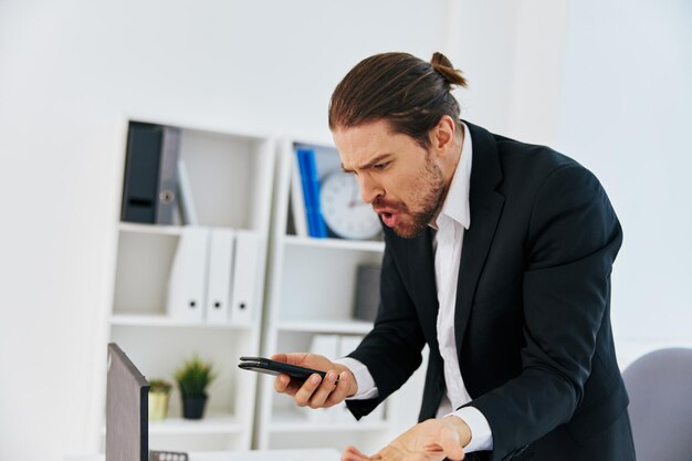 Manager at the desk documents communication by phone technology