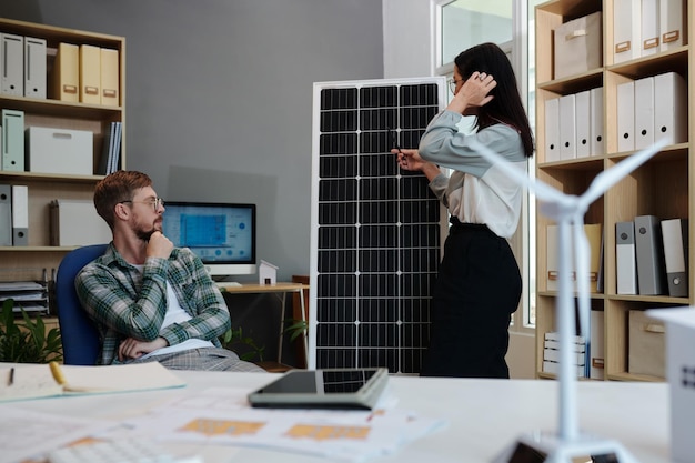 Manager and Engineer Discussing Solar Panel