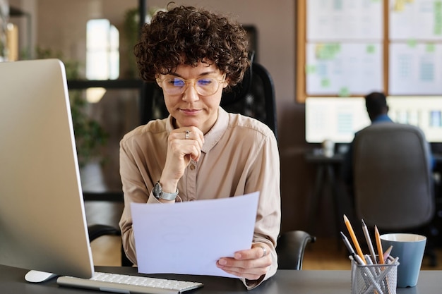 Photo manager examining contract at office