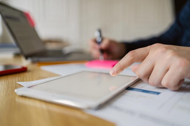 The manager of the finance and budget report in the office uses a laptop