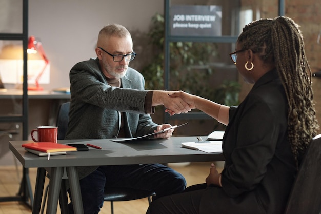 Manager greeting candidate at job interview