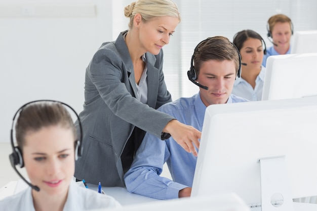 Manager helping call centre employee