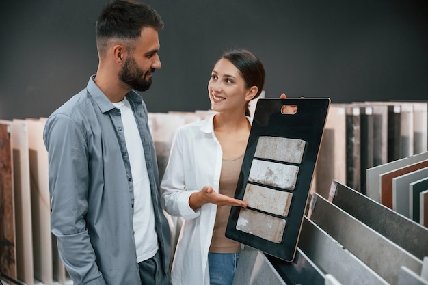 Manager helping visitor Woman and man is in the store of goods for the home