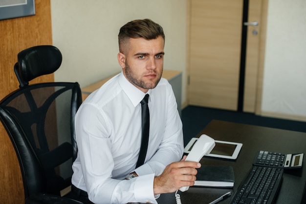 Photo the manager is on the phone in his office. business, finance