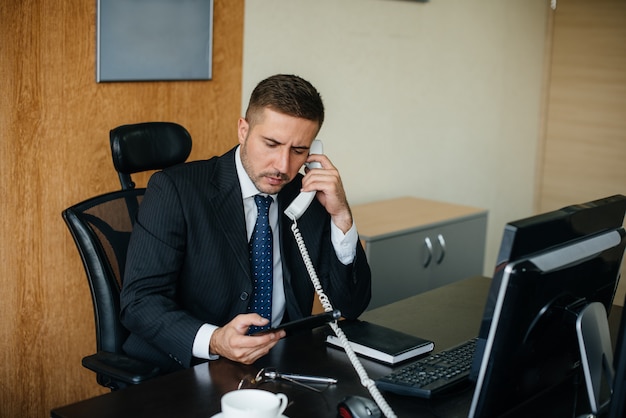 The Manager is on the phone in his office. Business, Finance