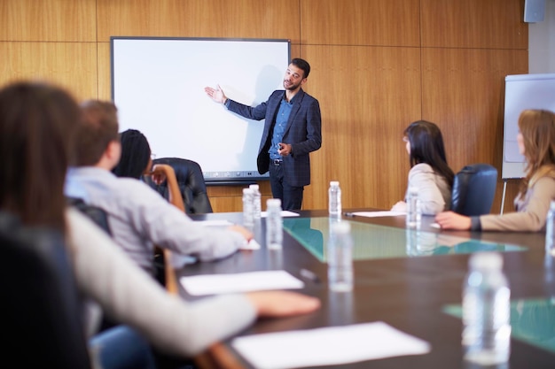 Manager leading business meeting in boardroom