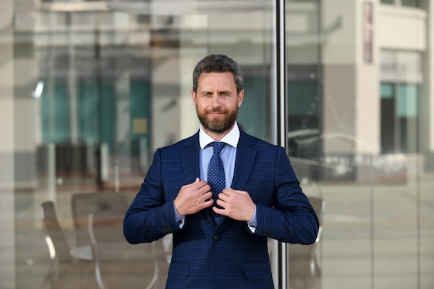 Manager in a luxury modern open space business center. Successful business man outside.