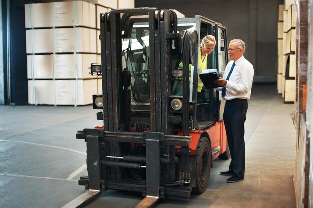 Manager planning forklift logistics with factory employee for supply chain industrial shipping and warehouse manufacturing Cargo truck machine for industry container production and freight storage