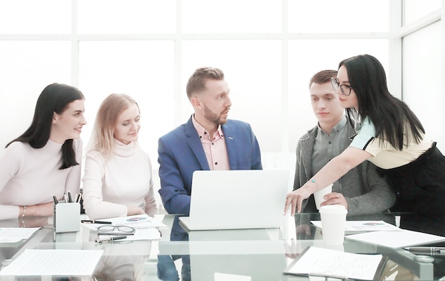 Manager pointing to laptop screen during working meeting . people and technology