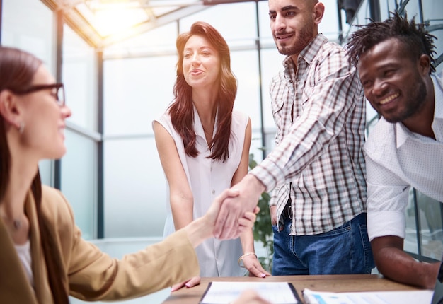 Manager shaking the hand of a female applicant