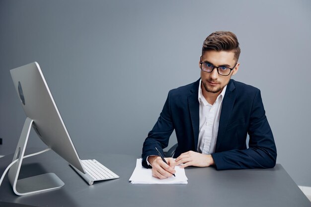 Manager sitting at a desk in front of a computer isolated\
background high quality photo