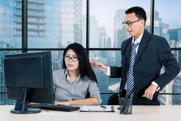 Manager support his partner while work in office