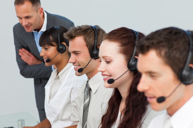 Manager talking to his team in a call center