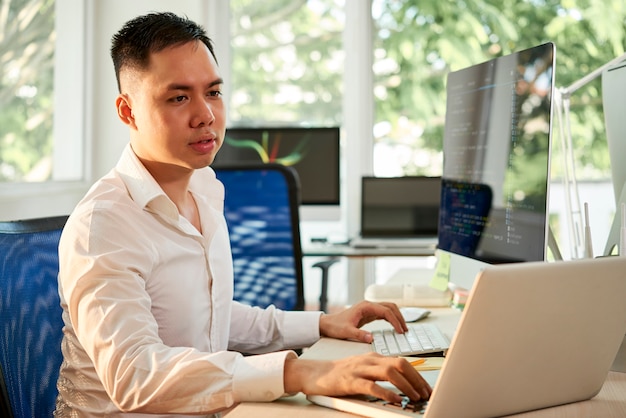 Manager using two computers in his work