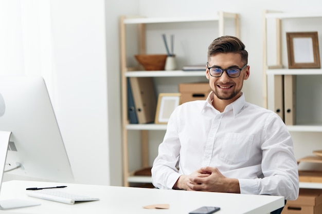 Manager wearing glasses sits at a desk office worked\
office