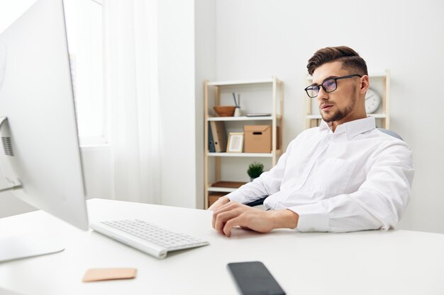 Manager wearing glasses sits at a desk office worked\
office