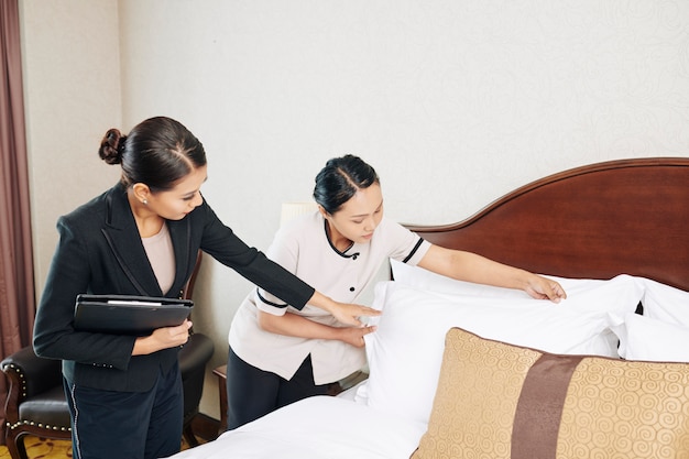 Manager with maid working in the hotel