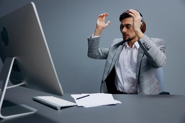 Manager working at the computer in headphones in the office\
technologies