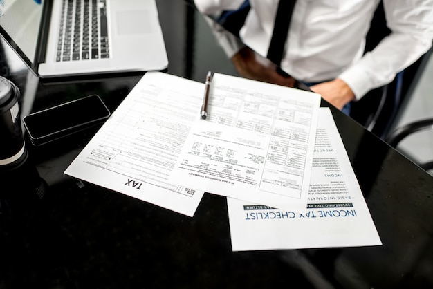 Manager working with tax documents. Image focused on the documents