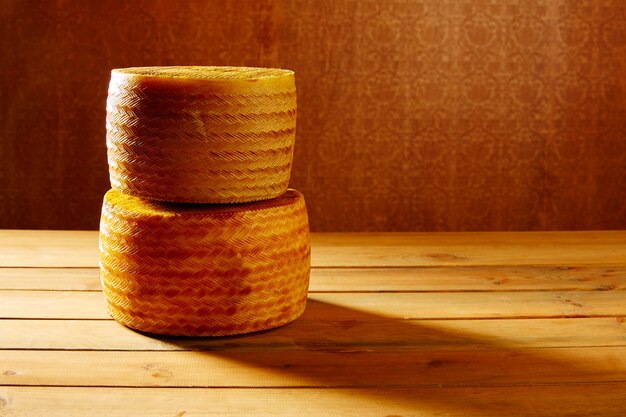 Manchego cheese from Spain on wooden table