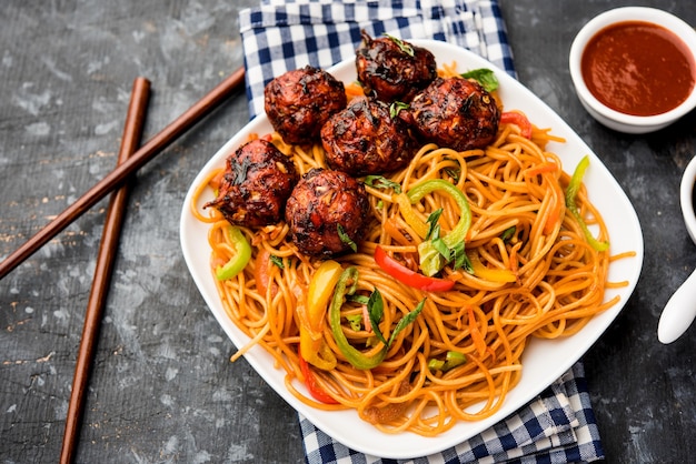 Manchurian Hakka or Schezwan noodles, popular indochinese food served in a bowl. selective focus