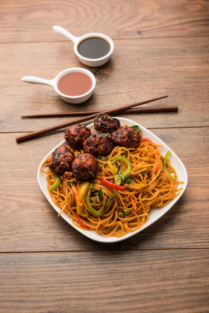 Manchurian Hakka or Schezwan noodles, popular indochinese food served in a bowl. selective focus