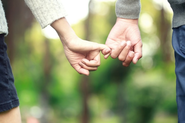 Mand and woman holding hands