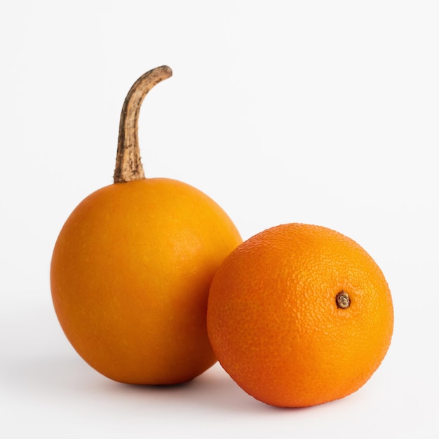 Mandarin and decorative pumpkin on a white background